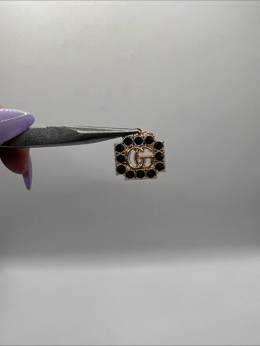 1430. Gold and Black Crystal Logo Charm Pendant